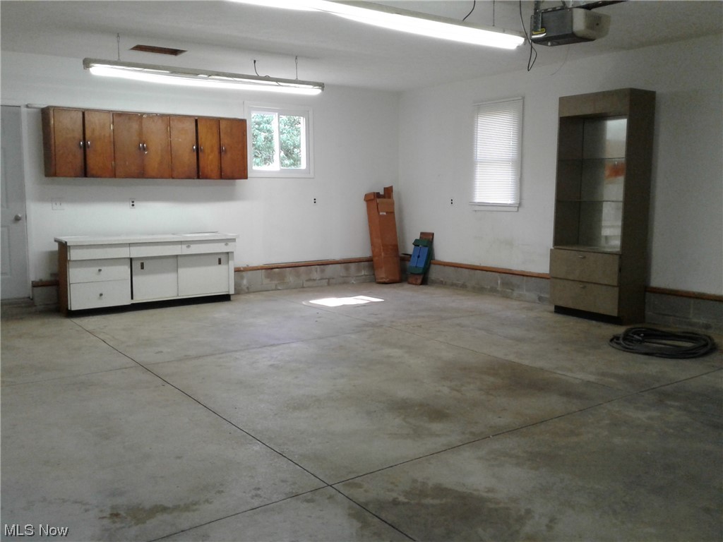 5566 Linn Road Amherst, OH 44001 - Photo 24 of 32 Garage with storage cabinets and backdoor to the backyard.