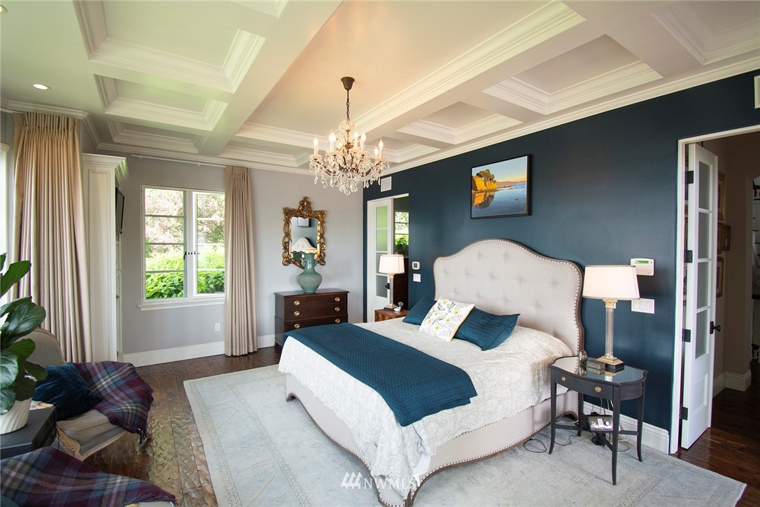 8635 Fauntleroy Way Southwest Seattle, WA 98136 - Photo 9 of 36 a bedroom with a large bed and a chandelier