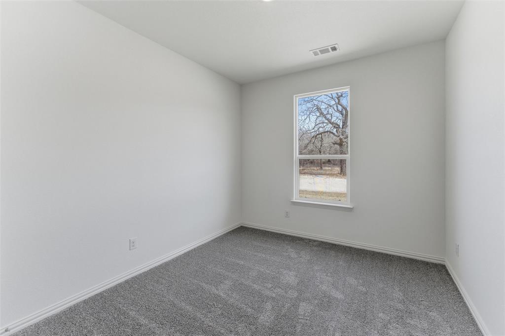 144 Oak Grv Way Springtown, TX 76082 - Photo 21 of 27 a view of an empty room with a window