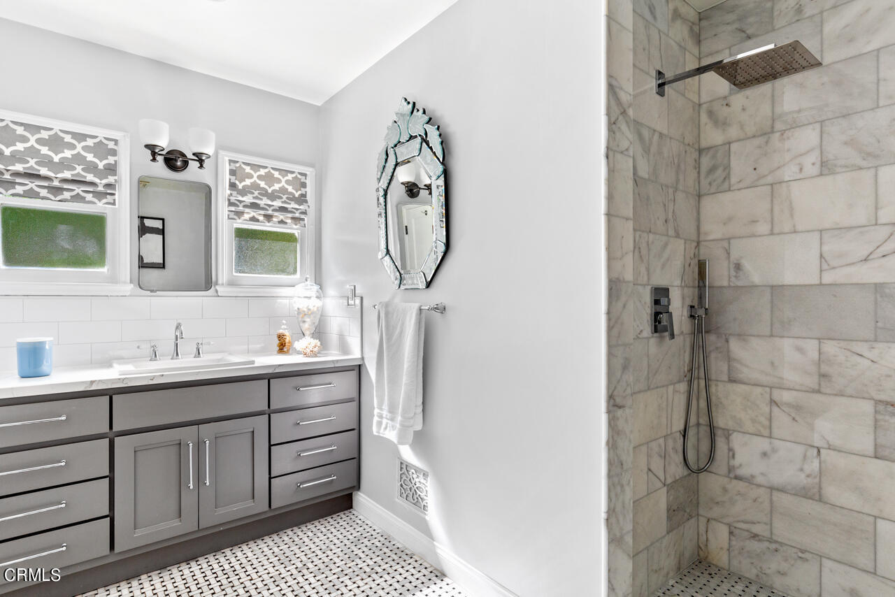 2355 Brigden Road Pasadena, CA 91104 - Photo 17 of 30 a bathroom with a sink a mirror and shower