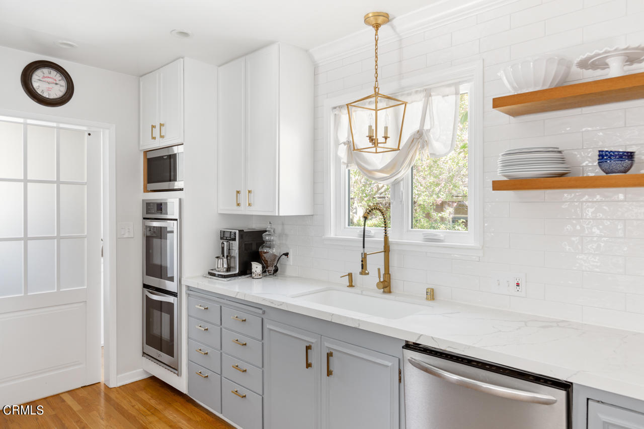 2355 Brigden Road Pasadena, CA 91104 - Photo 8 of 30 a kitchen with stainless steel appliances white cabinets and a window