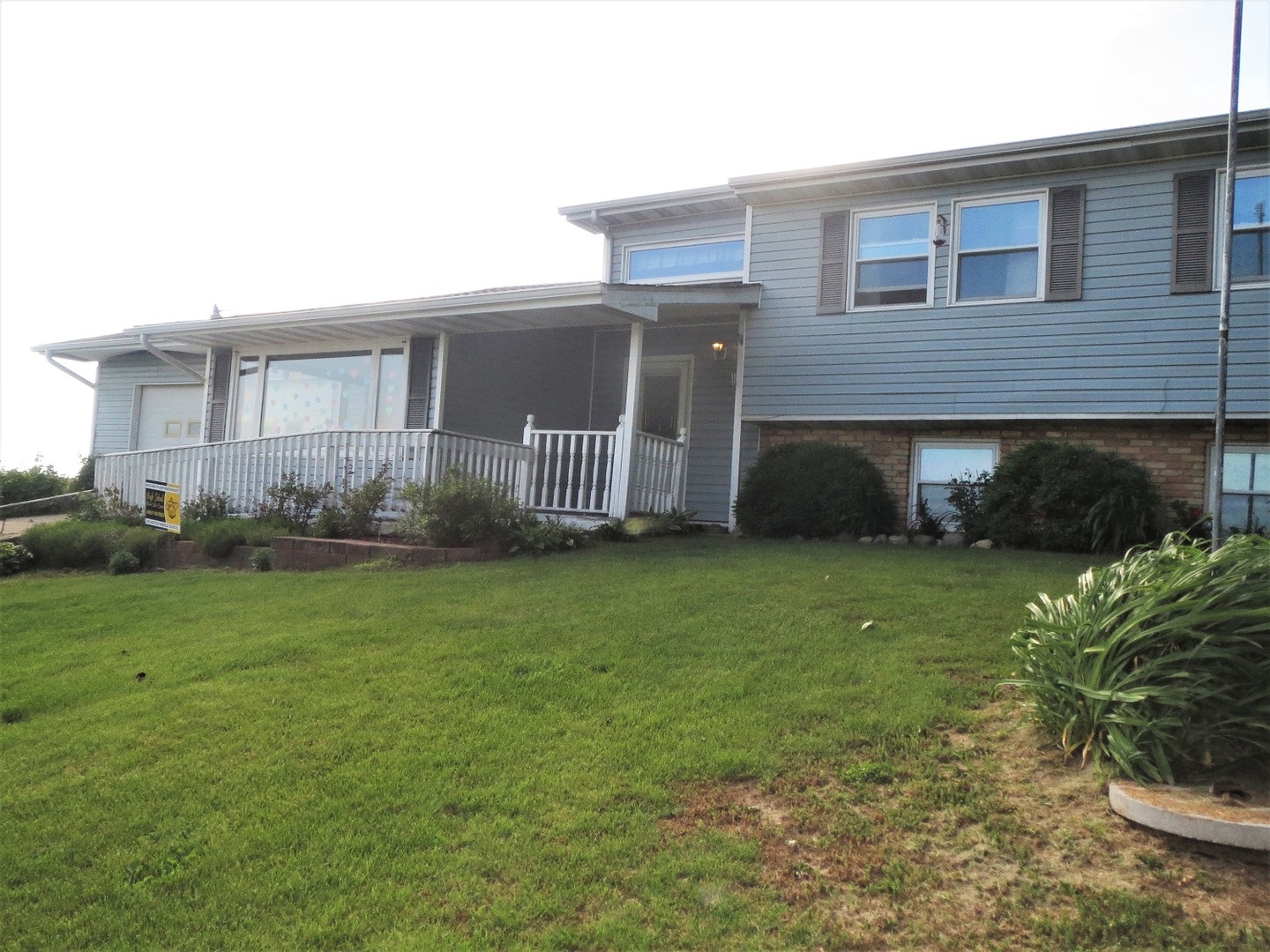 9536 West Woosung Road Dixon, IL 61021 - Photo 1 of 24 a front view of a house with a garden