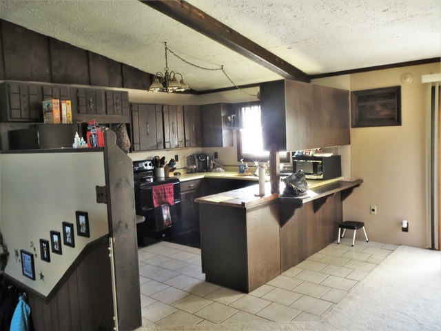 9536 West Woosung Road Dixon, IL 61021 - Photo 5 of 24 a kitchen filled with stainless steel appliances granite countertop a sink and a refrigerator