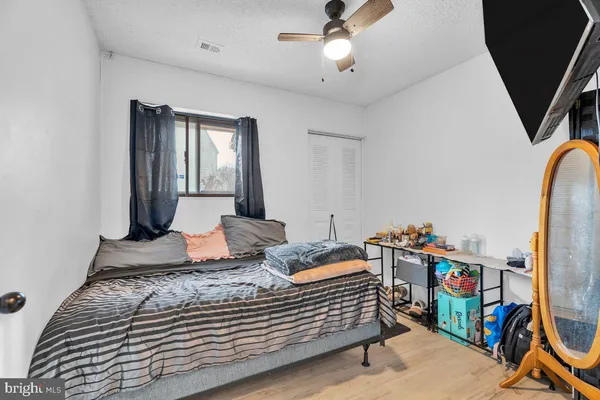a bedroom with bed and wooden floor