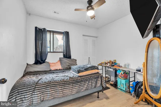 a bedroom with bed and wooden floor