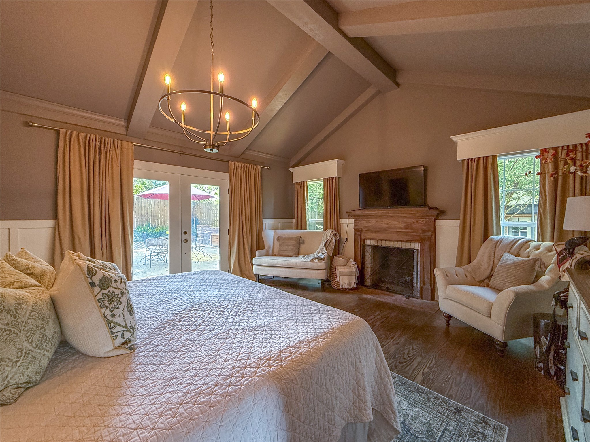 1704 Harrison Road Brenham, TX 77833 - Photo 11 of 34 a spacious bedroom with a large bed and a fireplace