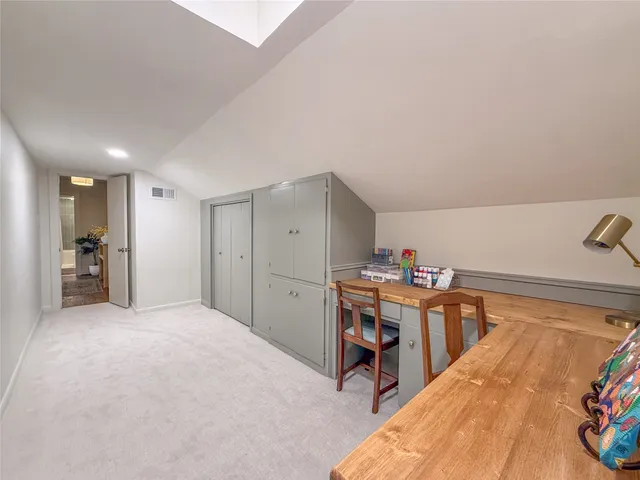 a view of a bedroom with furniture and closet