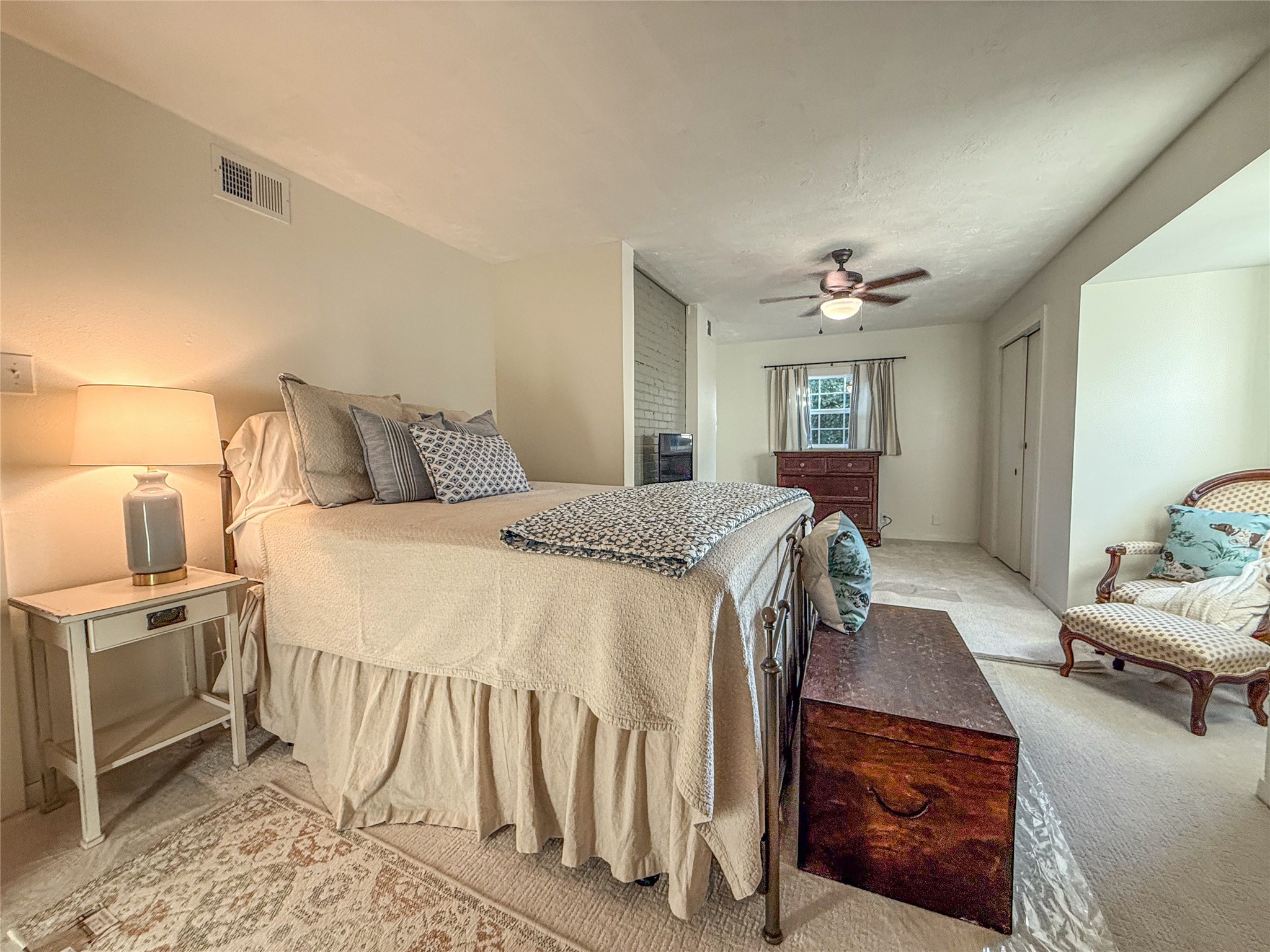 1704 Harrison Road Brenham, TX 77833 - Photo 18 of 34 a bedroom with a bed and a chandelier