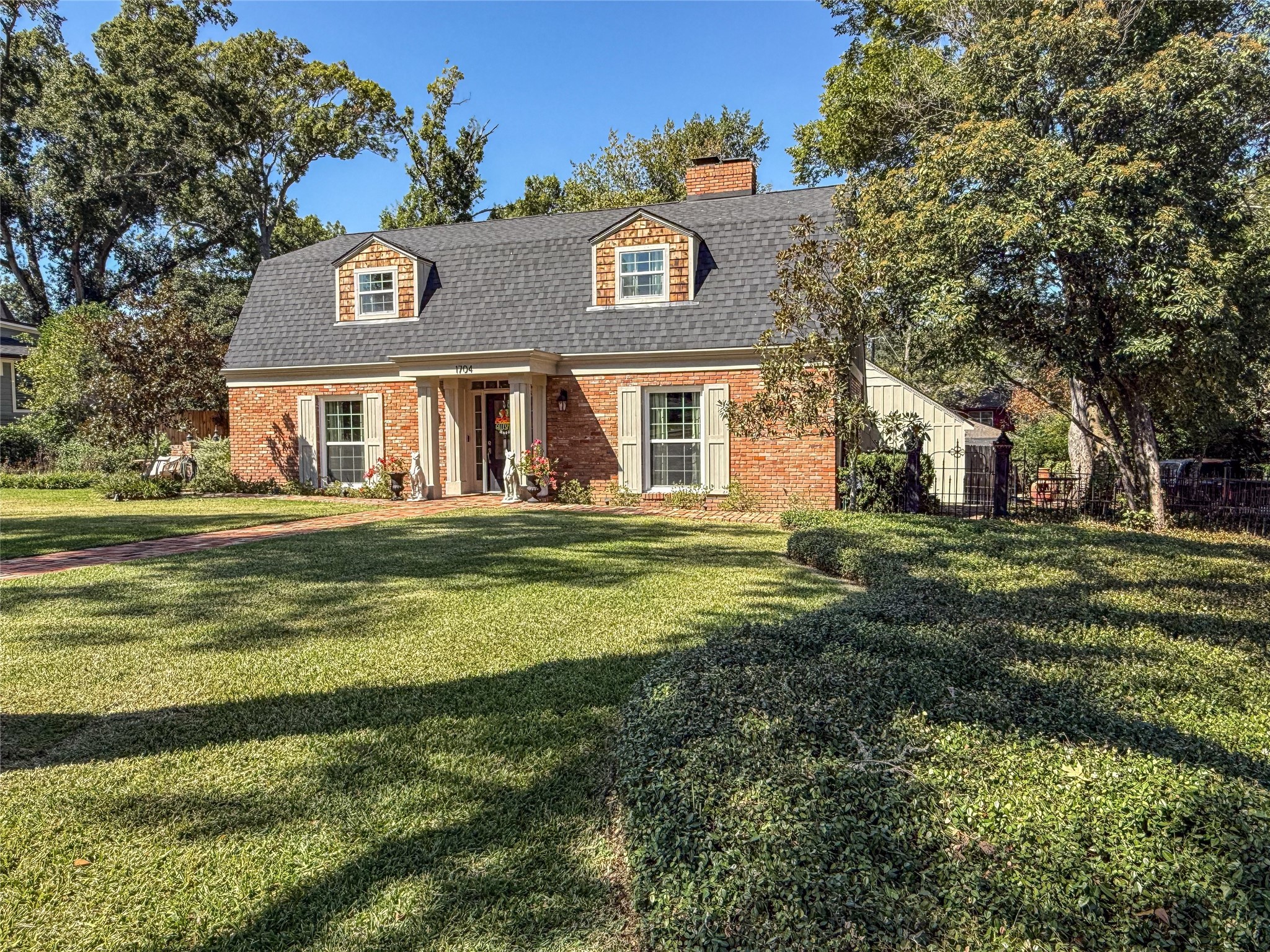 1704 Harrison Road Brenham, TX 77833 - Photo 2 of 34 a front view of a house with a garden