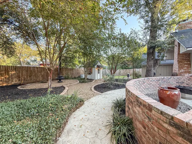 a view of a backyard with wooden fence