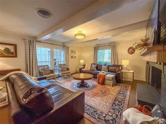 a living room with furniture a rug and a window