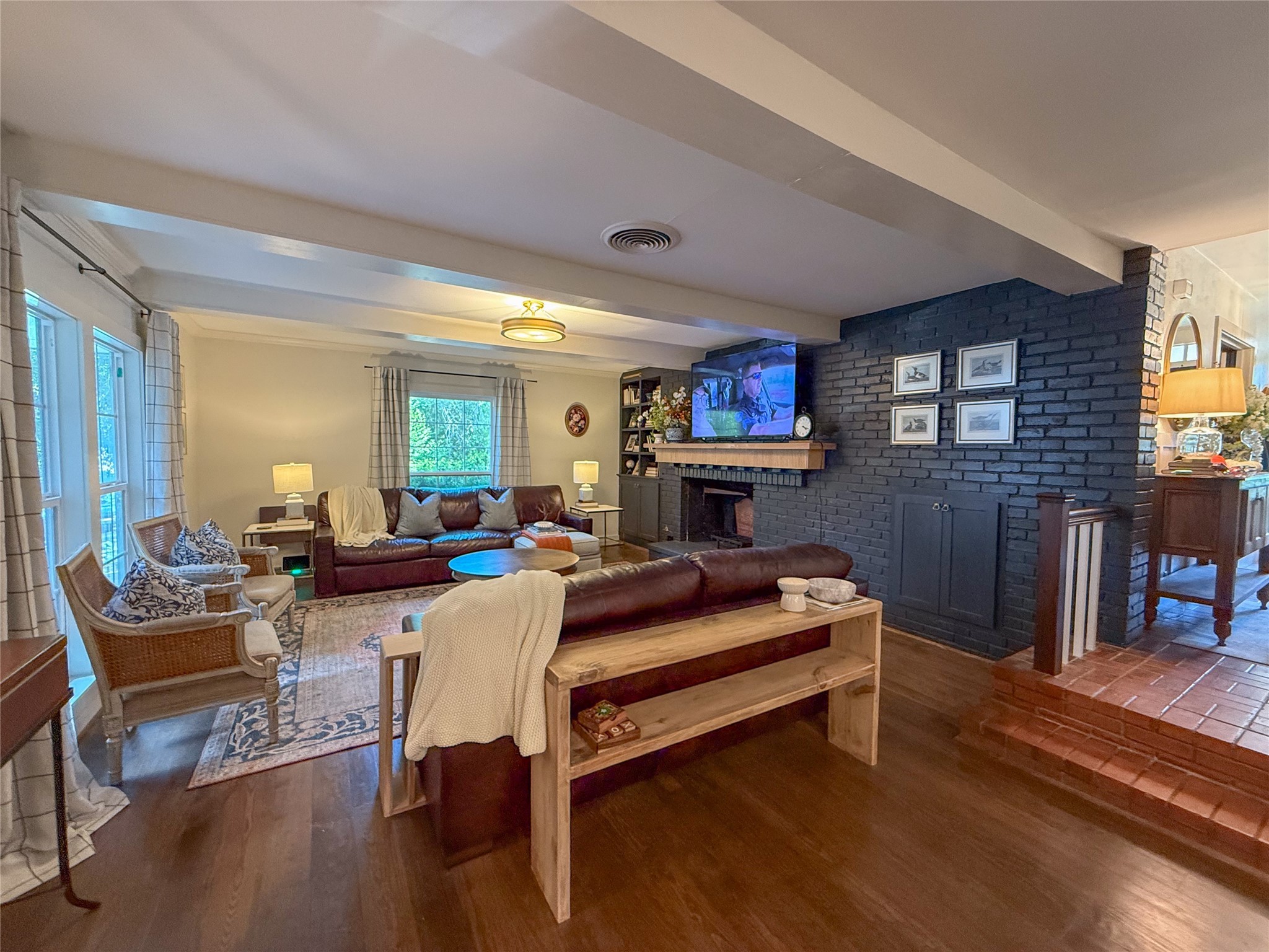 1704 Harrison Road Brenham, TX 77833 - Photo 5 of 34 a living room with furniture a fireplace and a flat screen tv