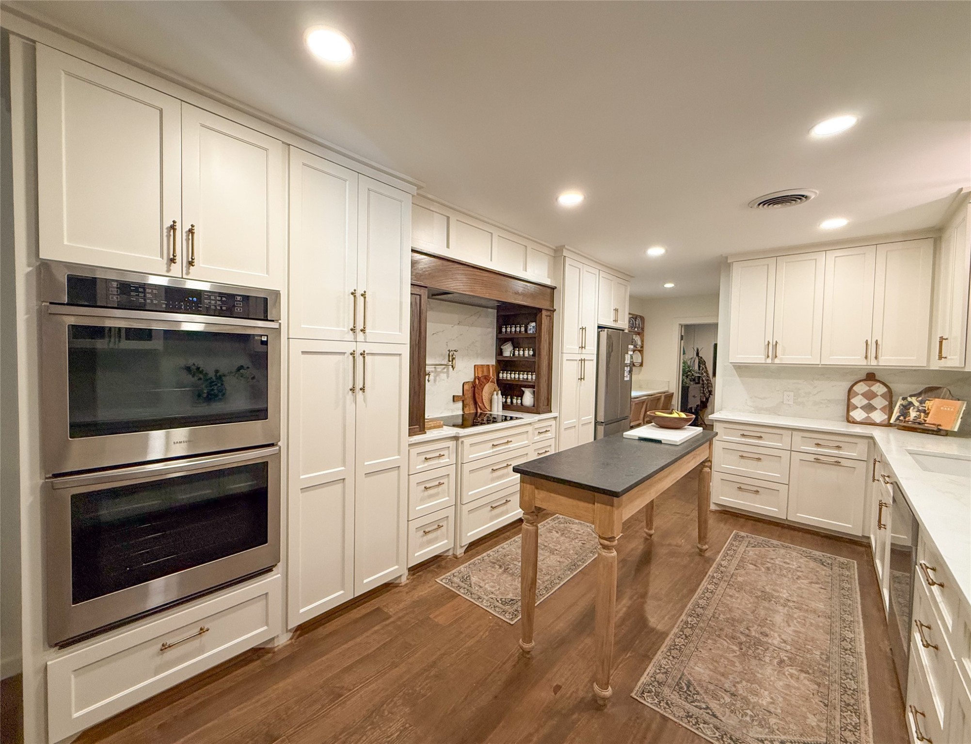 1704 Harrison Road Brenham, TX 77833 - Photo 6 of 34 a kitchen with granite countertop stainless steel appliances and white cabinets