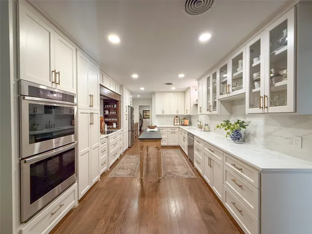 a large kitchen with stainless steel appliances kitchen island granite countertop a large counter top and stainless steel appliances