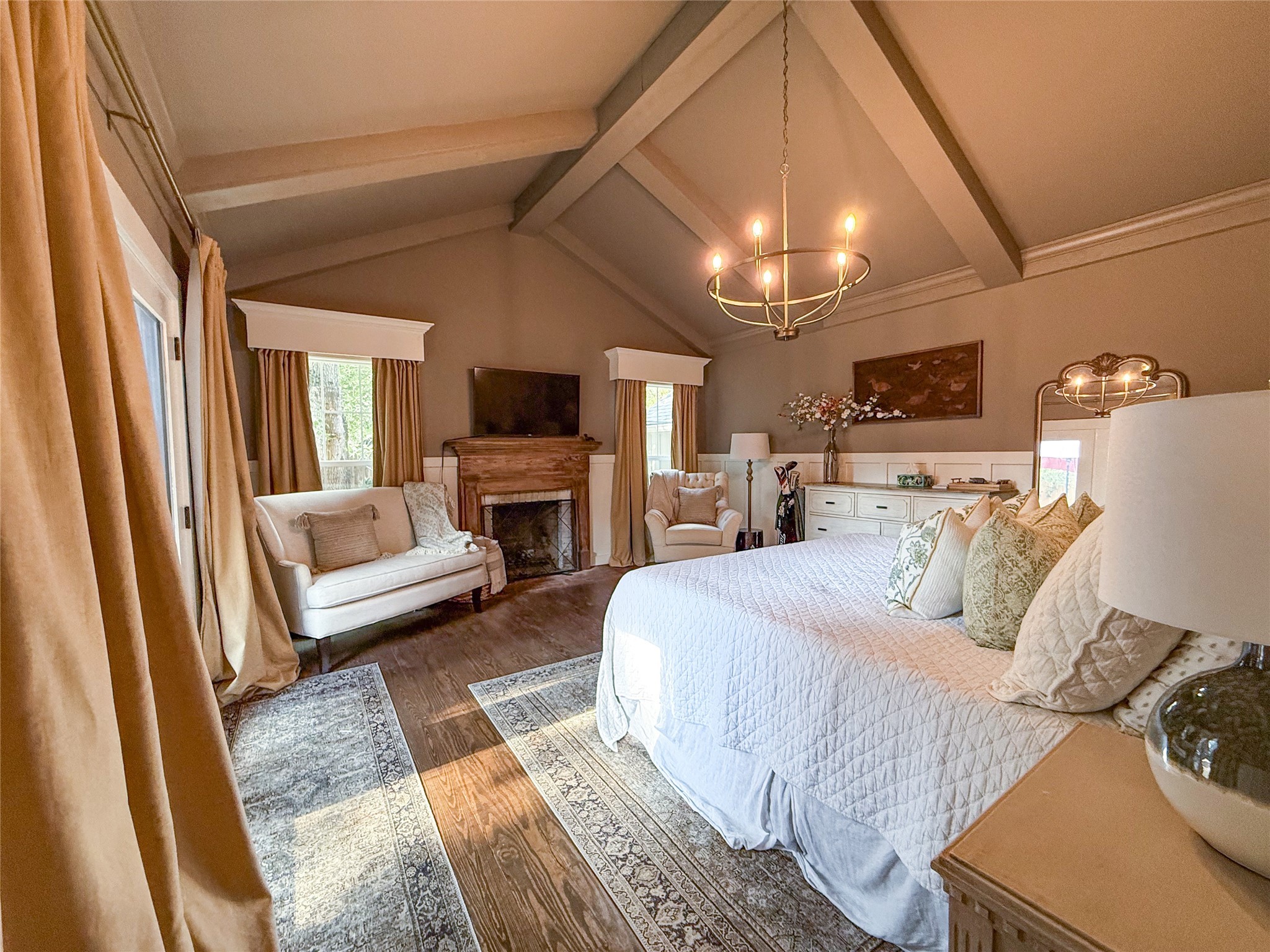 1704 Harrison Road Brenham, TX 77833 - Photo 10 of 34 a bedroom with a bed wooden floor and a fireplace