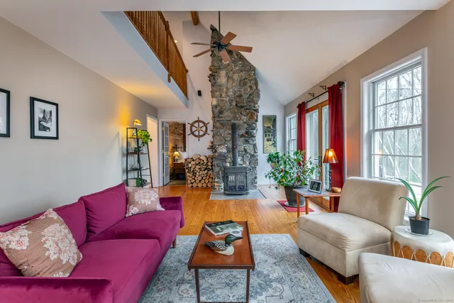 a living room with furniture or couch and a chandelier