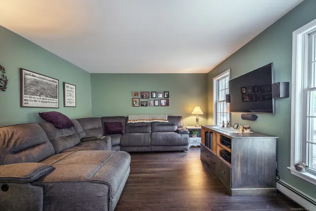 a living room with furniture and wooden floor