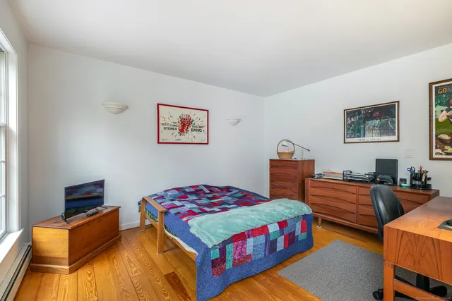 a bedroom with bed and a couch