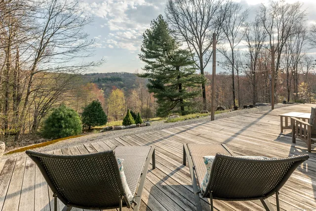 a view of a chairs and table on the roof deck