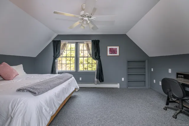 a spacious bedroom with a bed and a chandelier