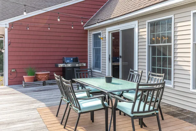 a table and chairs in front of a house