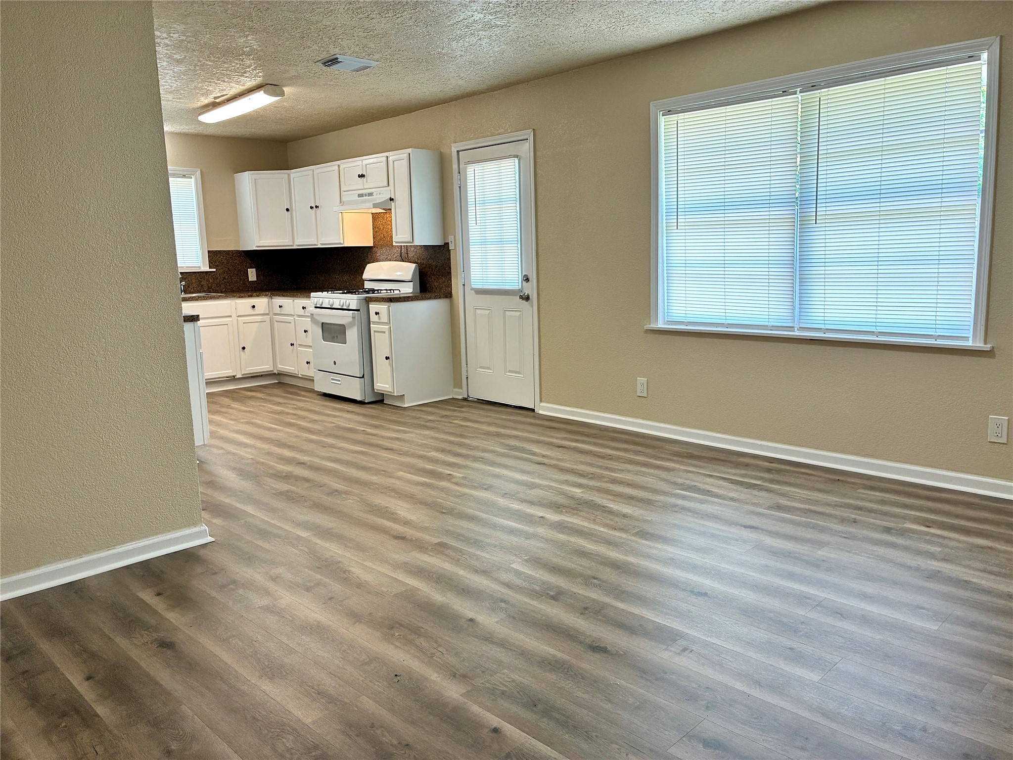 631 Roper Street Houston, TX 77034 - Photo 13 of 15 The large dining room flows into the kitchen and features fresh paint and new vinyl plank flooring.
