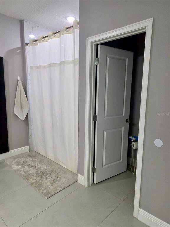 697 James Court Kissimmee, FL 34759 - Photo 12 of 17 a view of a bathroom with a shower and a sink