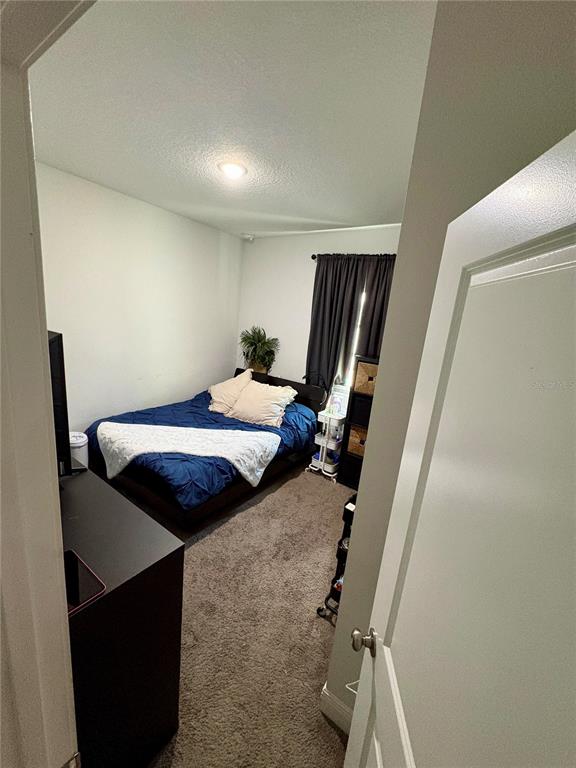 697 James Court Kissimmee, FL 34759 - Photo 13 of 17 a bed room with furniture and a mirror