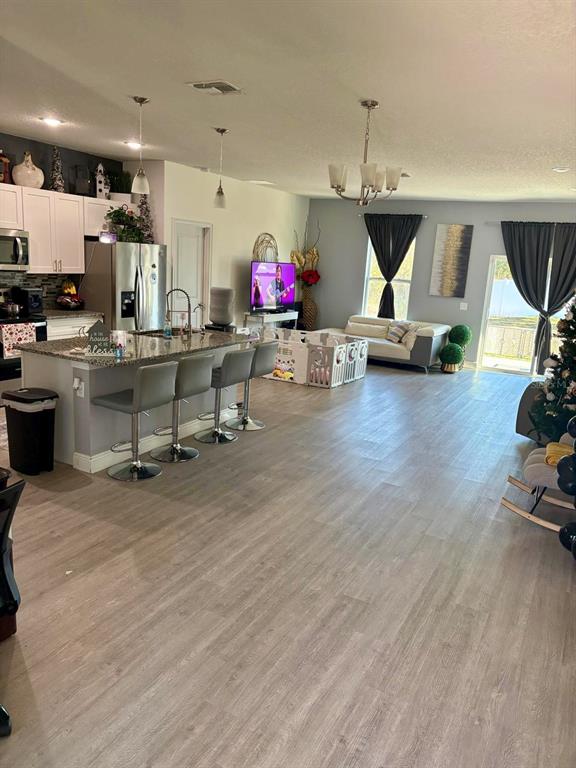 697 James Court Kissimmee, FL 34759 - Photo 5 of 17 a room with lots of wooden furniture and a wooden floor