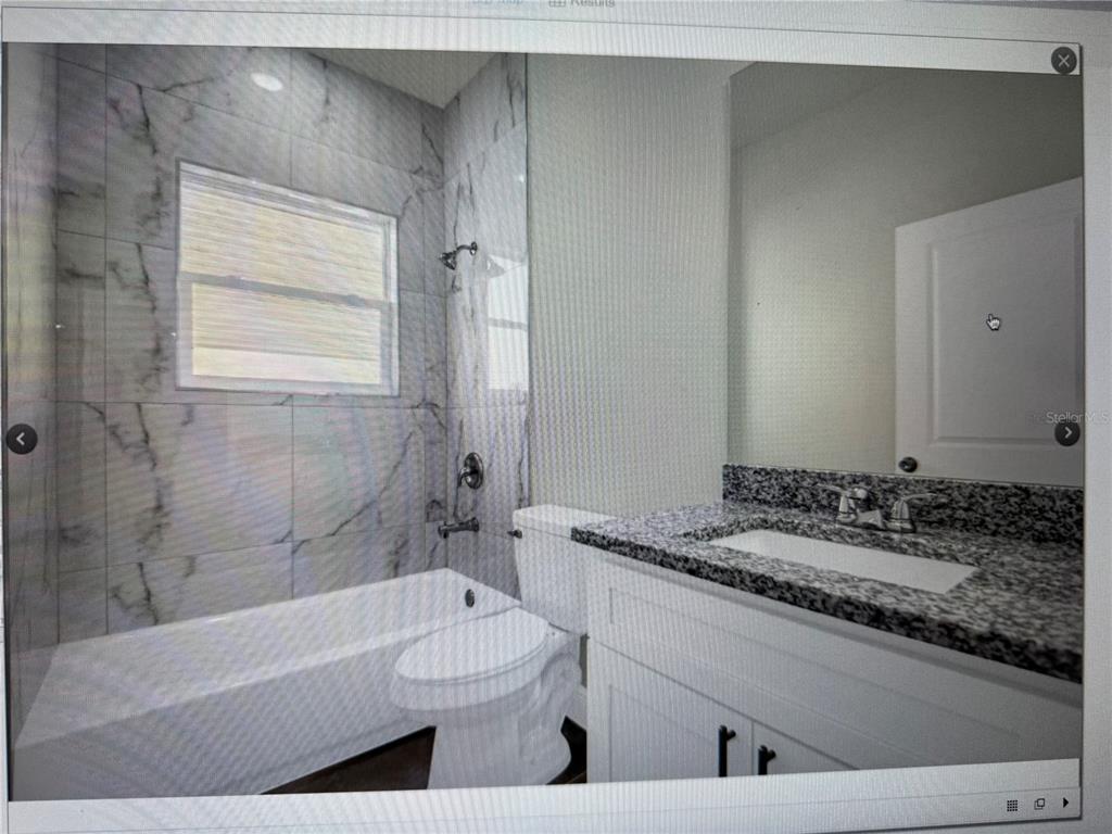 697 James Court Kissimmee, FL 34759 - Photo 6 of 17 a bathroom with a granite countertop sink a toilet and bathtub