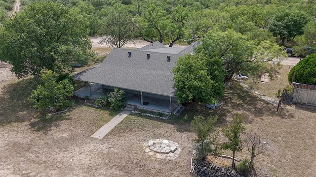 an aerial view of a house with yard and parking