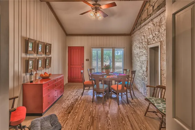 a dining room with furniture a chandelier and wooden floor