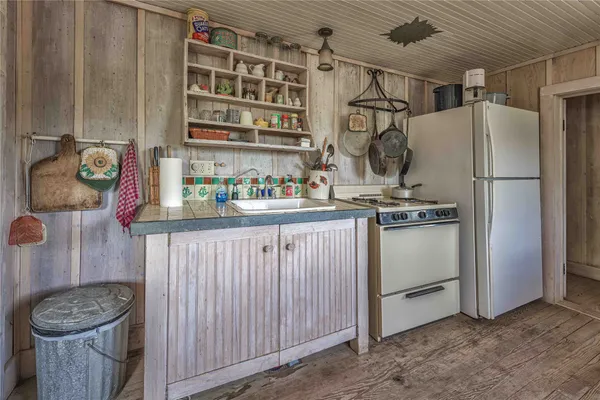 a kitchen with appliances cabinets and a table
