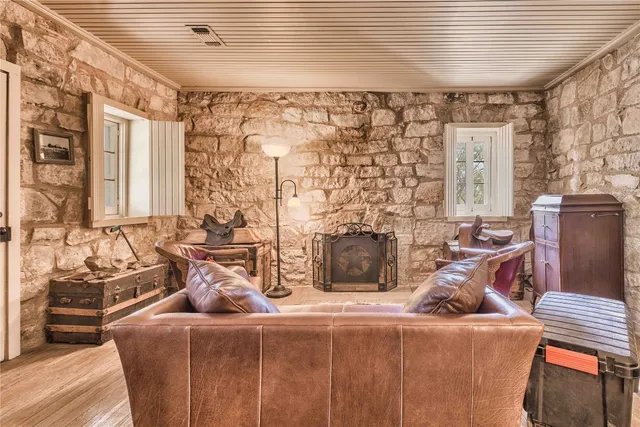 a living room with furniture a fireplace and a table