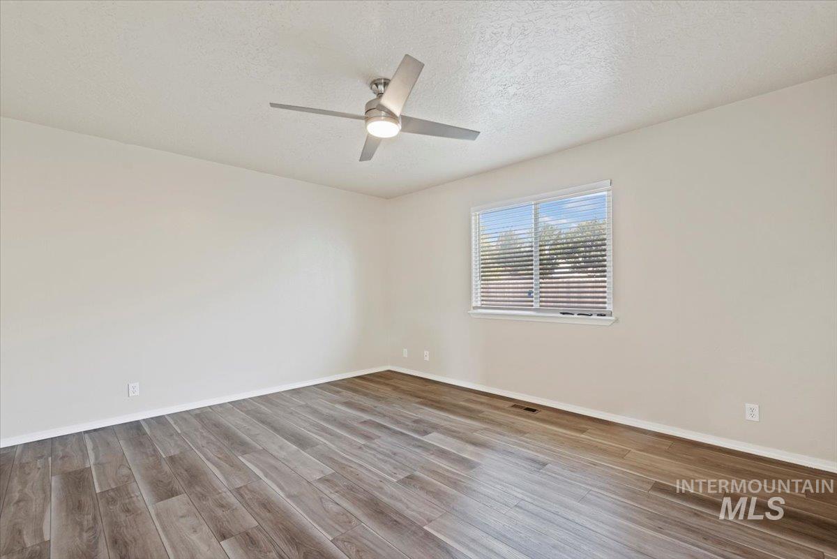 994 North Gray Cloud Way Meridian, ID 83642 - Photo 17 of 28 Spare room with a textured ceiling and light wood-style flooring