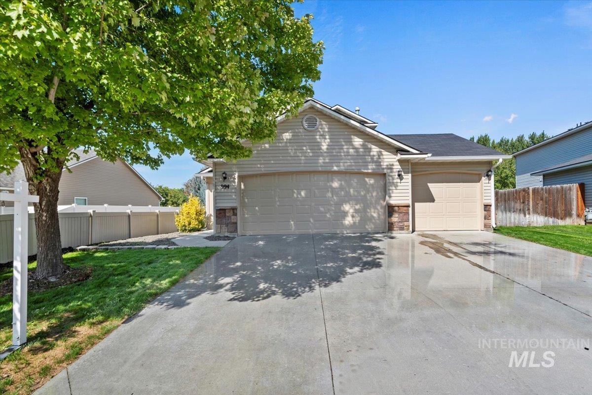 994 North Gray Cloud Way Meridian, ID 83642 - Photo 2 of 28 Ranch-style house with driveway, a garage, and stone siding