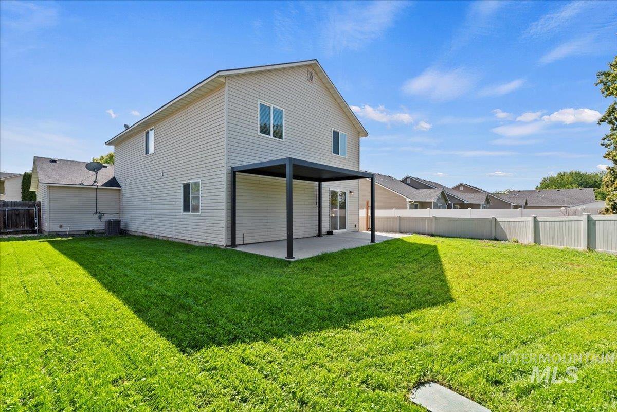 994 North Gray Cloud Way Meridian, ID 83642 - Photo 27 of 28 Back of property with a fenced backyard, a patio, and a residential view