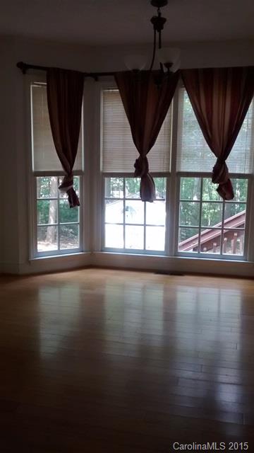 2464 Winding Trail Lane Fort Mill, SC 29708 - Photo 3 of 22 an empty room with wooden floor and windows