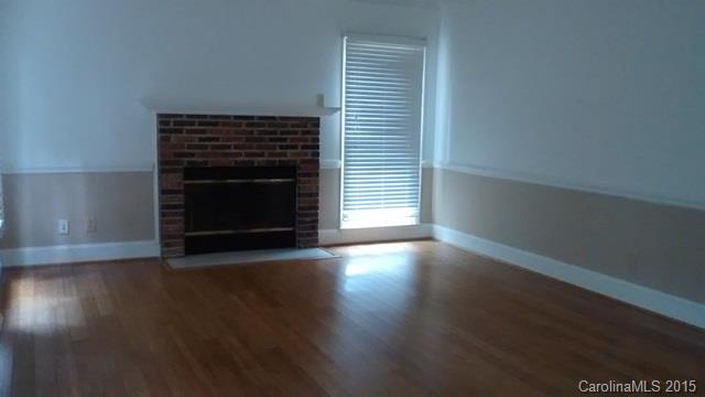 2464 Winding Trail Lane Fort Mill, SC 29708 - Photo 5 of 22 a view of an empty room with wooden floor fireplace and a window