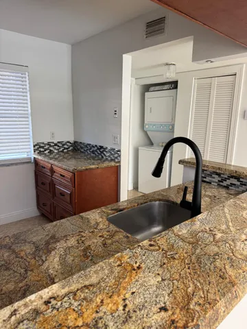 a kitchen with granite countertop a stove and a granite top