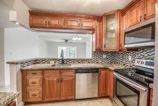 a kitchen with stainless steel appliances granite countertop a stove and a sink