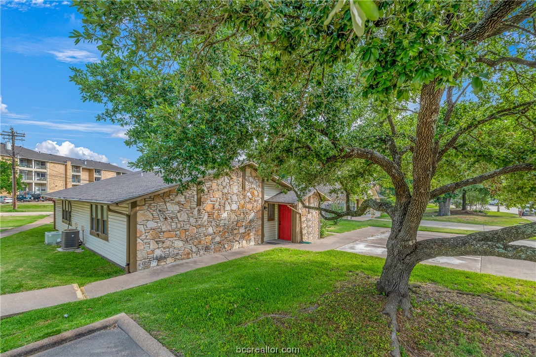 2323 De Lee Street, Unit 28 Bryan, TX 77802 - Photo 1 of 1 a view of a house with backyard and a tree