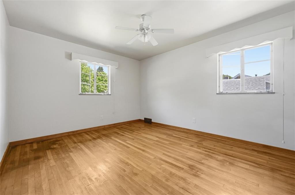 524 McElheny Road Glenshaw, PA 15116 - Photo 17 of 41 a view of an empty room with window and wooden floor