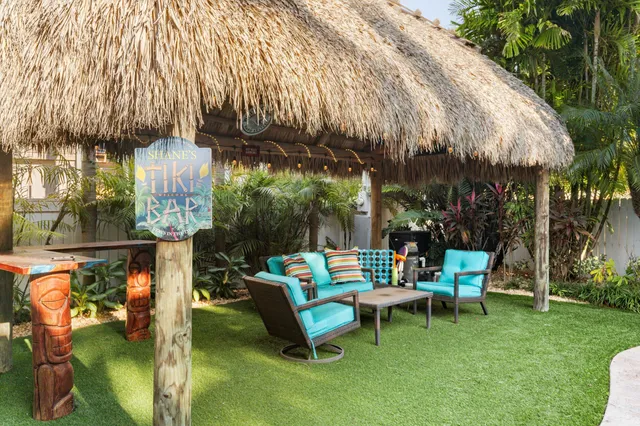 a view of a backyard with swimming pool and furniture