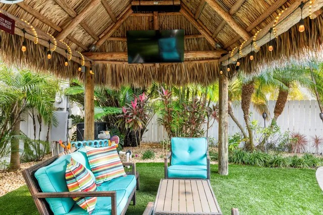 a swimming pool with outdoor seating and yard