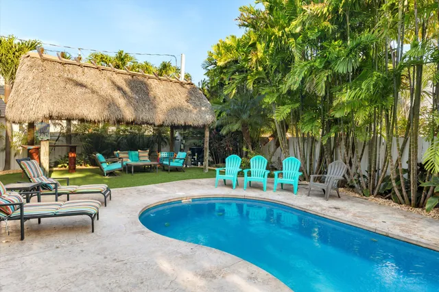 a view of a house with swimming pool and sitting area