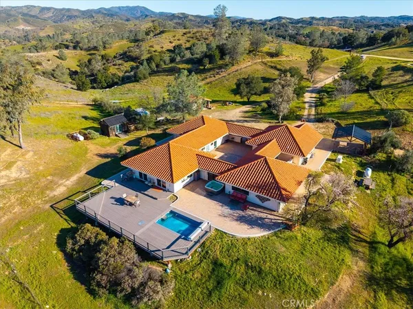 an aerial view of a house with a swimming pool
