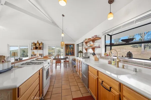 a kitchen with stainless steel appliances a sink stove and refrigerator