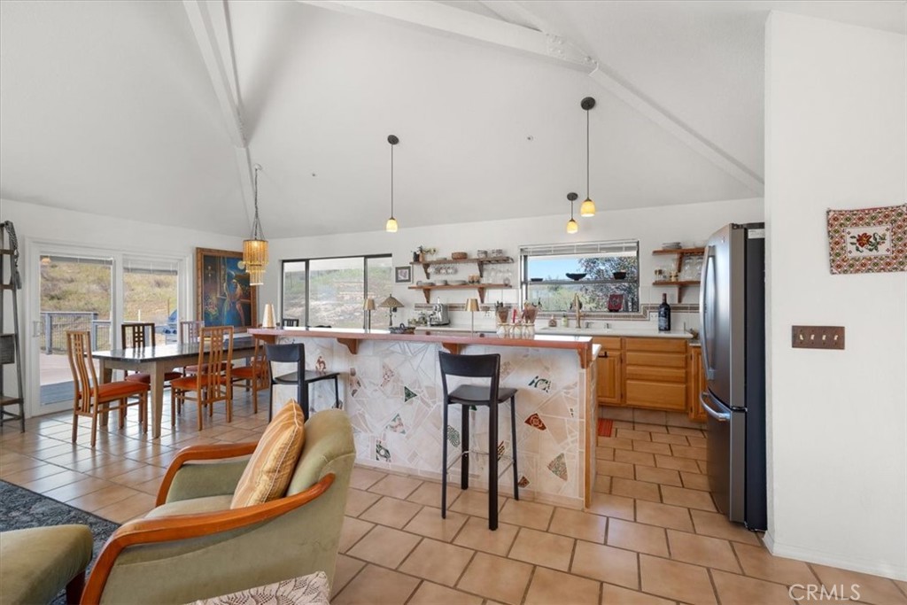 9750 Random Canyon Way Creston, CA 93432 - Photo 21 of 73 a dining hall with stainless steel appliances kitchen island granite countertop a table chairs and a view of living room