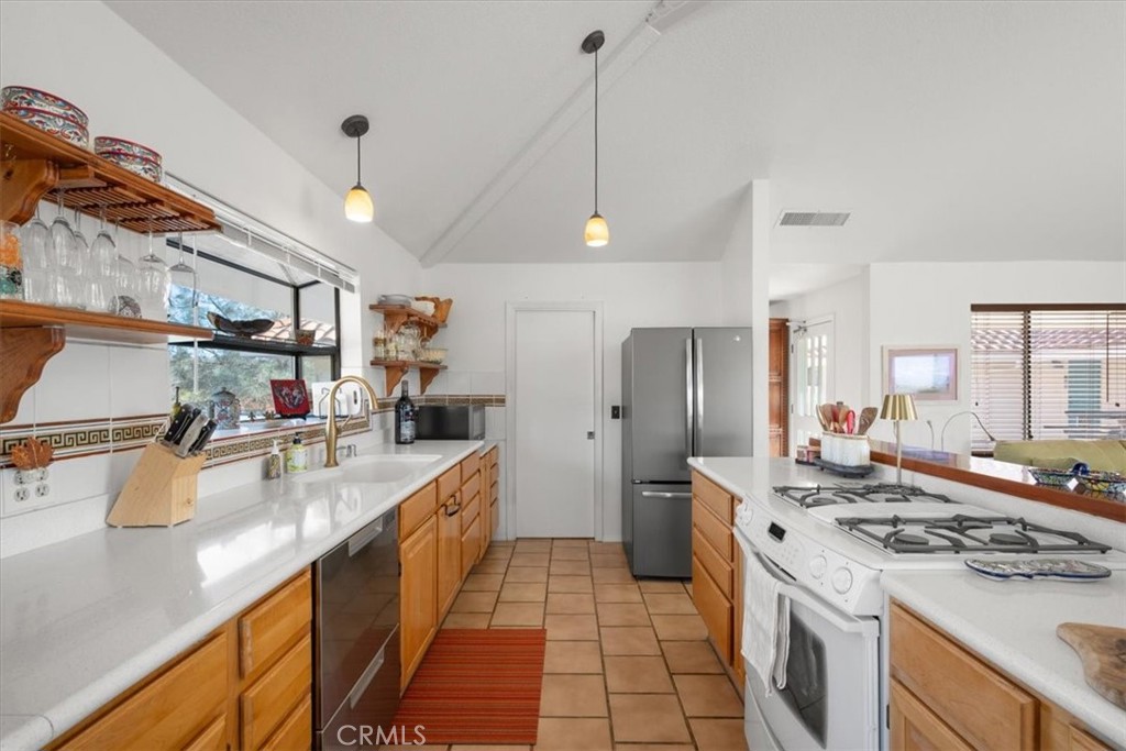 9750 Random Canyon Way Creston, CA 93432 - Photo 22 of 73 a kitchen with stainless steel appliances a sink stove and refrigerator